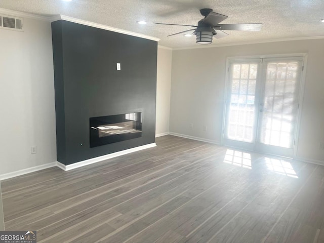 unfurnished living room with ornamental molding, visible vents, and ceiling fan