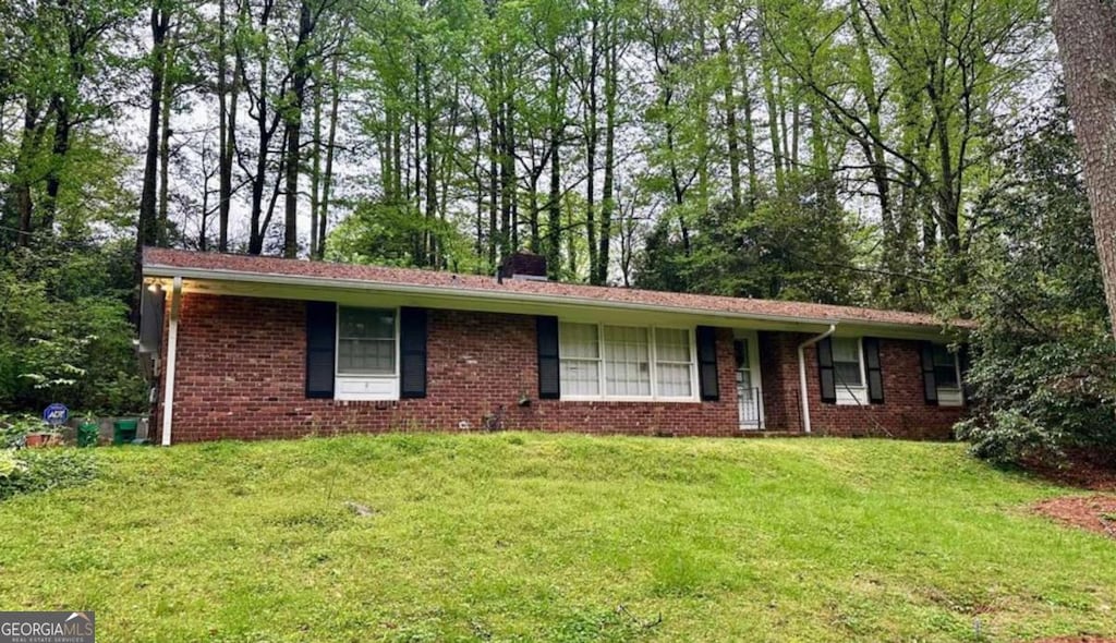 3059 Nottaway Ct, Atlanta, GA 30341 - ranch-style house featuring brick siding, a chimney, and a front lawn
