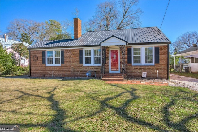 view of front of home featuring metal roof, brick siding, and a front lawn