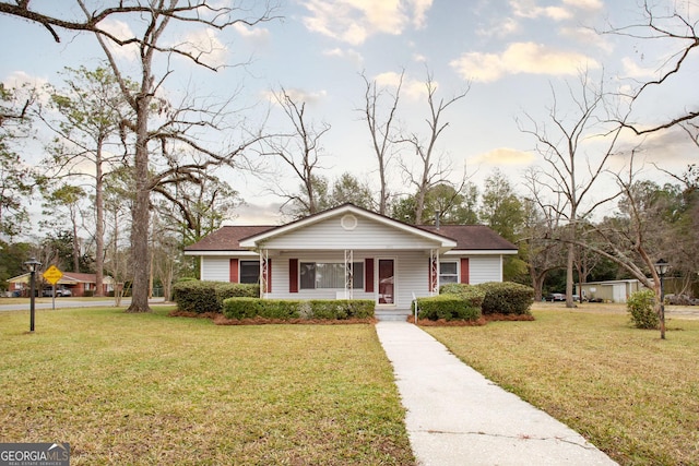 view of front of house with covered porch and a front yard