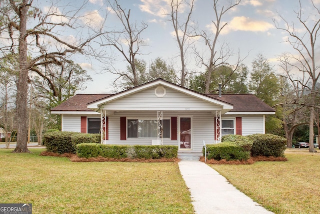 view of front of home with a front yard and covered porch