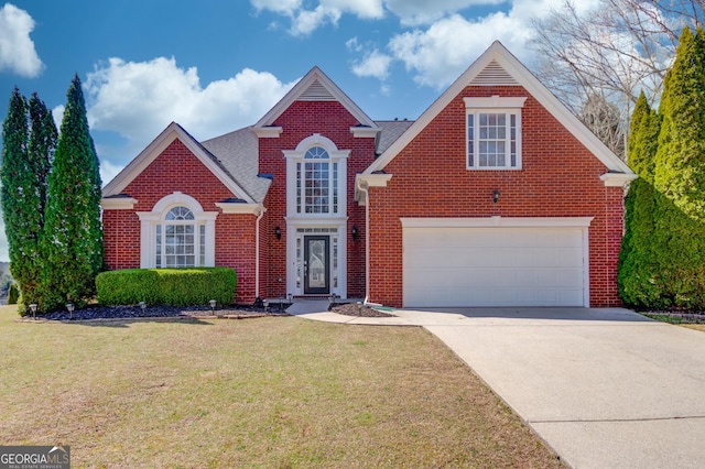 traditional-style home with a front yard, a garage, brick siding, and driveway