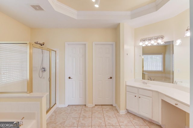 bathroom with visible vents, a shower stall, a tray ceiling, ornamental molding, and a bath