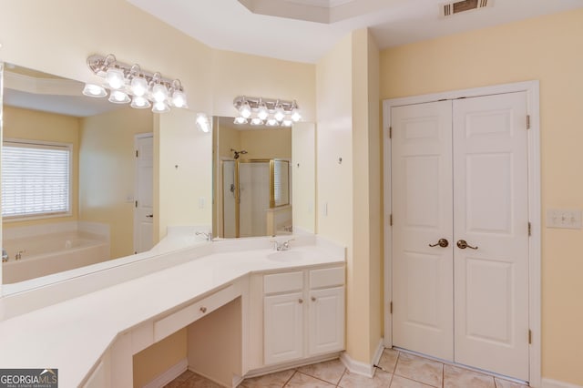 bathroom featuring vanity, visible vents, a stall shower, a garden tub, and tile patterned floors