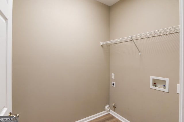 washroom with wood finished floors, baseboards, hookup for an electric dryer, hookup for a washing machine, and laundry area