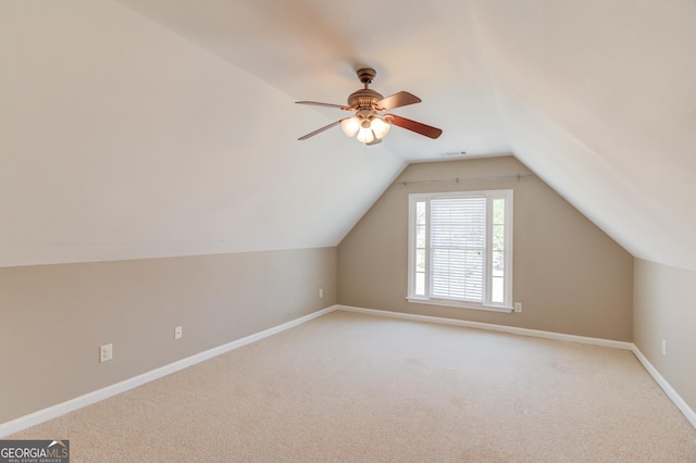 bonus room with visible vents, ceiling fan, baseboards, vaulted ceiling, and light carpet