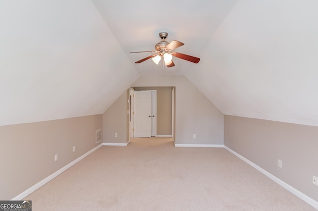 bonus room featuring visible vents, baseboards, lofted ceiling, carpet flooring, and a ceiling fan