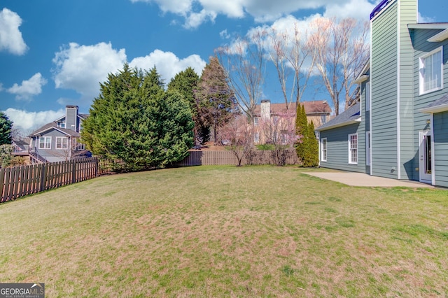 view of yard with a patio area and a fenced backyard