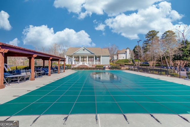 pool featuring a patio area and fence