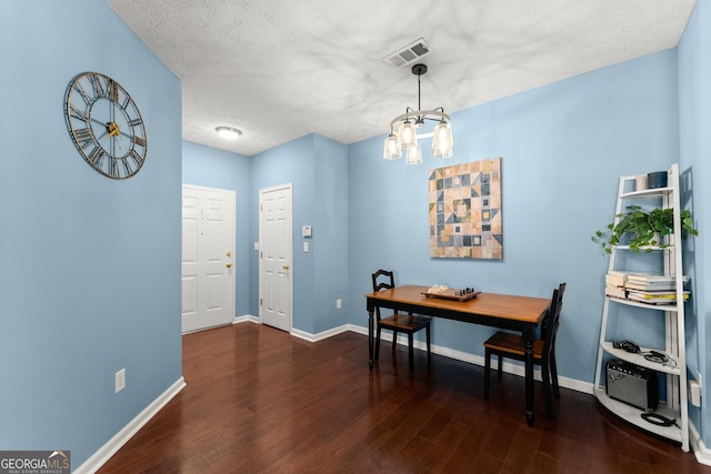 dining room featuring visible vents, baseboards, an inviting chandelier, and wood finished floors