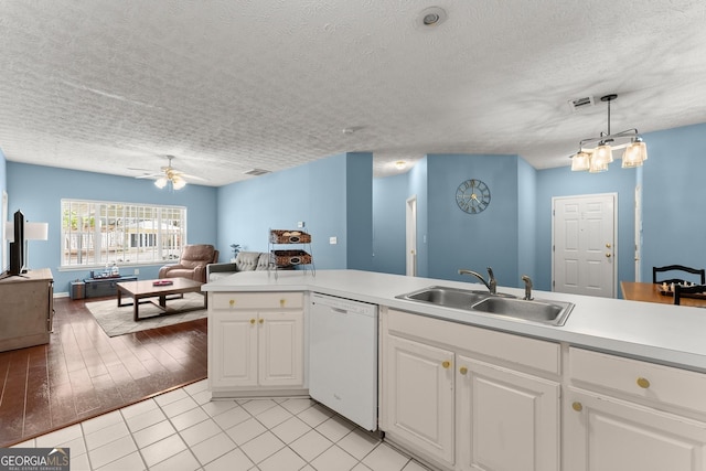 kitchen with a ceiling fan, visible vents, white dishwasher, a sink, and open floor plan