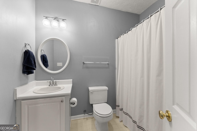 full bath with vanity, baseboards, a textured ceiling, tile patterned floors, and toilet