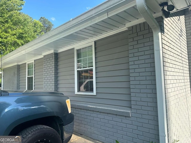 view of side of home with brick siding