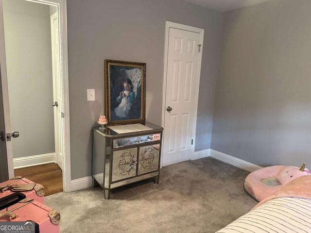 bedroom featuring baseboards and carpet