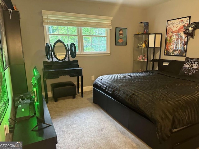 bedroom featuring carpet and baseboards