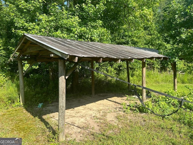view of yard with a view of trees and a carport