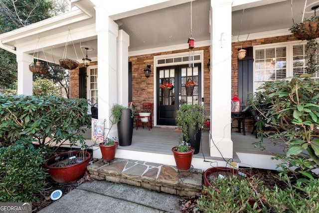 entrance to property with stone siding and covered porch