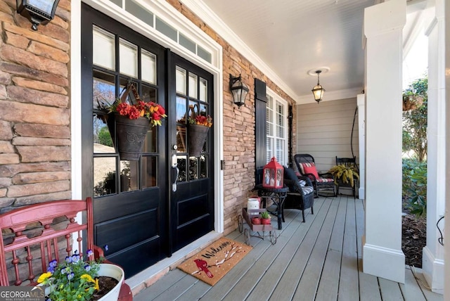 entrance to property featuring stone siding and covered porch