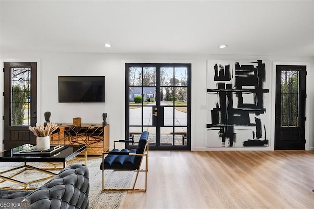 living area with recessed lighting and wood finished floors