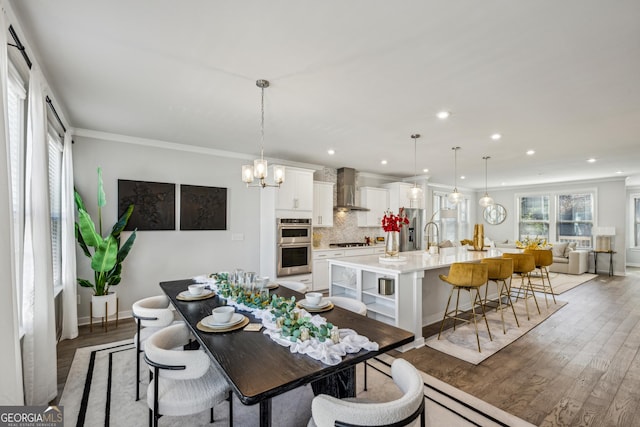 1322 Stanley Park Dr, Decatur, GA 30033 - dining room featuring light wood-type flooring, recessed lighting, ornamental molding, and an inviting chandelier
