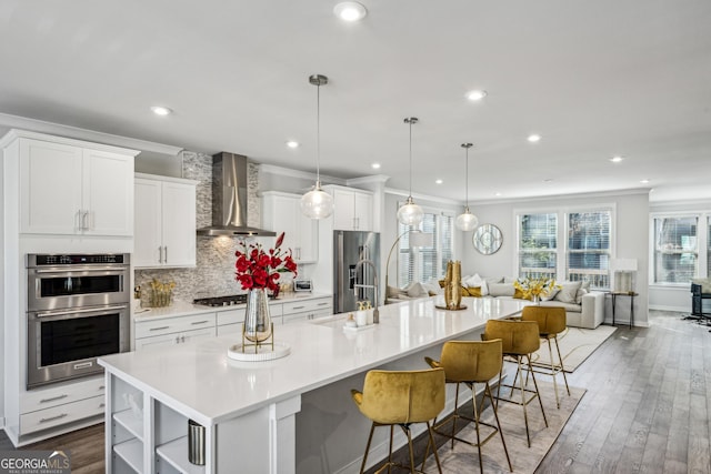 1322 Stanley Park Dr, Decatur, GA 30033 - kitchen featuring white cabinetry, wall chimney exhaust hood, light countertops, and appliances with stainless steel finishes