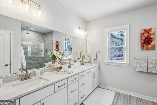 1322 Stanley Park Dr, Decatur, GA 30033 - full bathroom featuring a sink, a shower stall, wood finished floors, baseboards, and double vanity