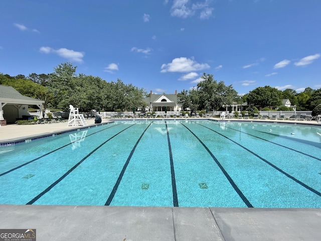 community pool featuring view of scattered trees
