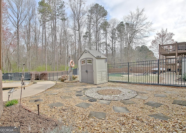 exterior space with an outbuilding, a storage unit, and fence