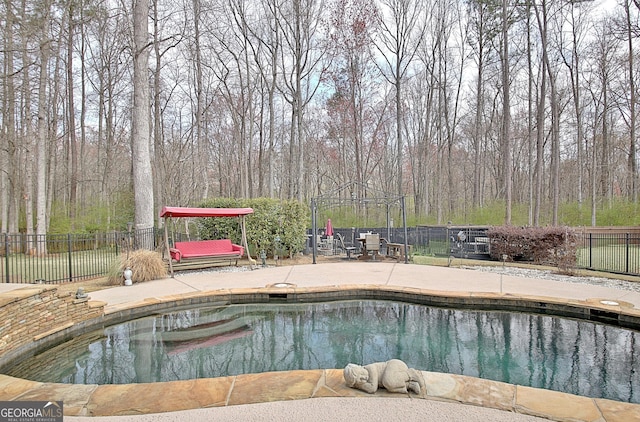 view of pool featuring a fenced in pool, a patio, and fence