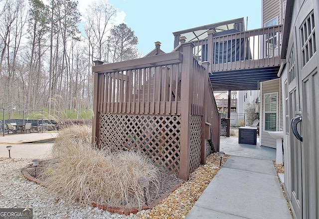 view of side of home with a wooden deck