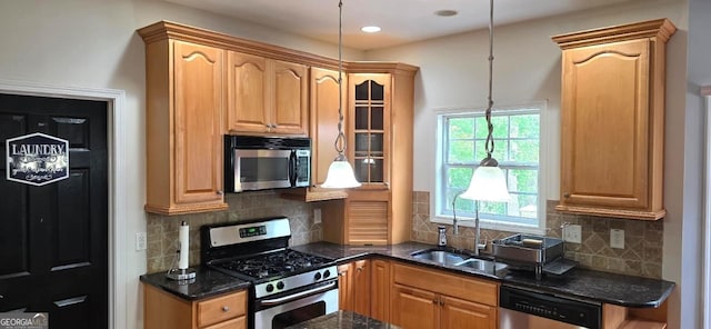 kitchen featuring stainless steel appliances, a sink, glass insert cabinets, dark stone countertops, and backsplash