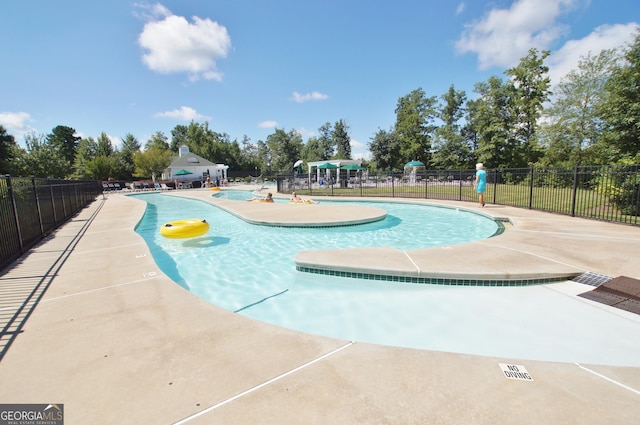 pool featuring a patio and fence