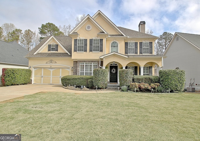 view of front of house with stucco siding, central air condition unit, driveway, a front lawn, and a chimney