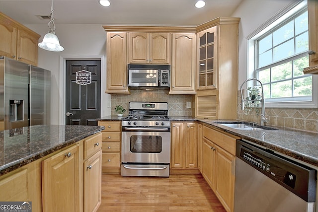 65 Tapestry Ln, Newnan, GA 30265 - kitchen featuring stainless steel appliances, a sink, light brown cabinets, light wood finished floors, and glass insert cabinets