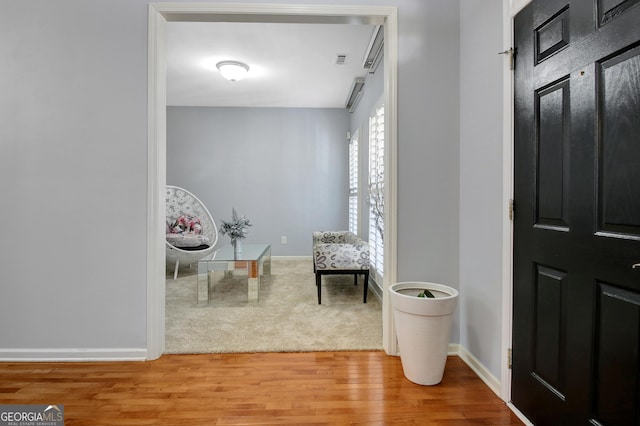 entryway with baseboards and wood finished floors