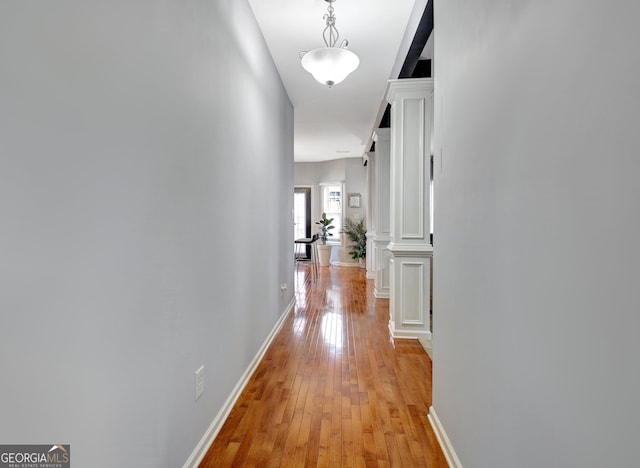 hall with light wood finished floors and baseboards