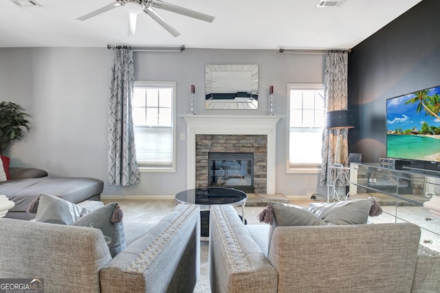 living room with carpet flooring, a healthy amount of sunlight, visible vents, and ceiling fan