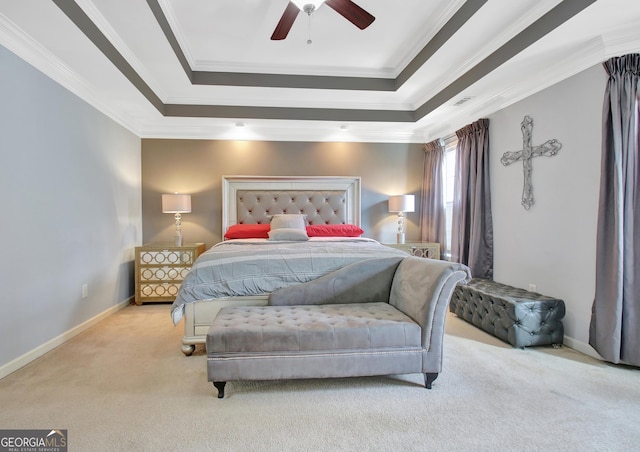 bedroom featuring a raised ceiling, crown molding, and carpet