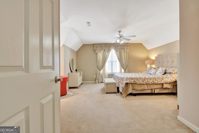 bedroom with carpet floors, vaulted ceiling, baseboards, and ceiling fan