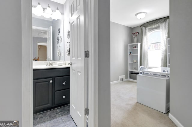 bathroom with vanity, baseboards, and visible vents