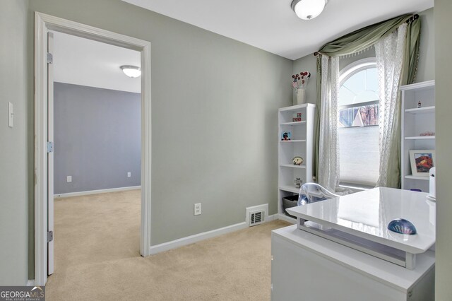 office space with visible vents, light colored carpet, and baseboards