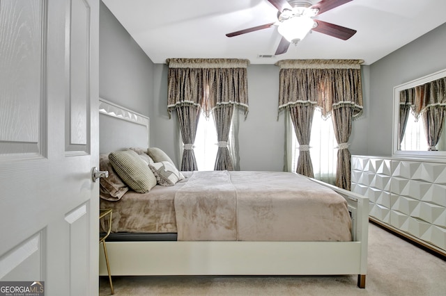 bedroom featuring carpet flooring, multiple windows, and visible vents