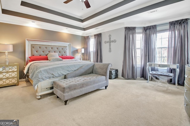 bedroom with ornamental molding, carpet, multiple windows, a raised ceiling, and ceiling fan