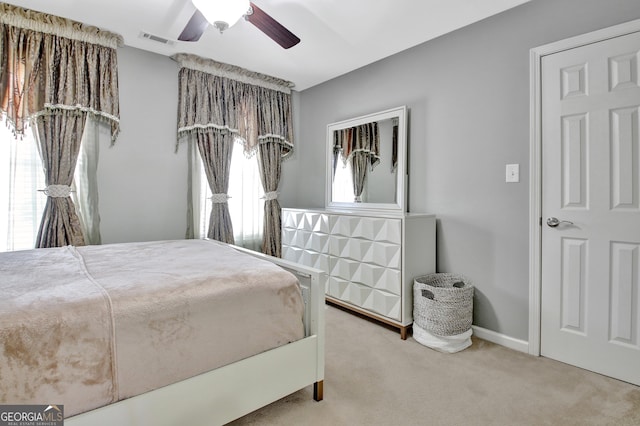 bedroom with visible vents, baseboards, carpet, and a ceiling fan