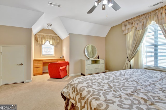 carpeted bedroom with lofted ceiling, baseboards, and visible vents