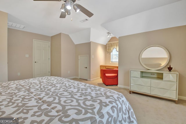 carpeted bedroom with visible vents, a ceiling fan, baseboards, and vaulted ceiling