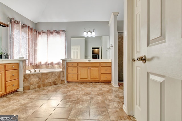 bathroom featuring a shower, vanity, lofted ceiling, and a garden tub