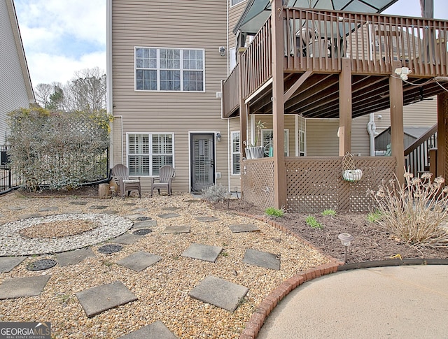 back of property featuring a wooden deck