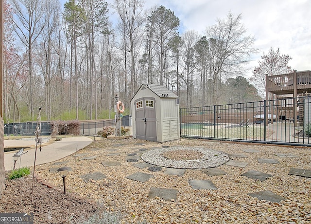 view of patio with a shed, fence, and an outdoor structure