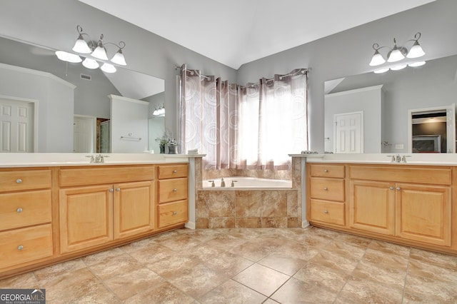 bathroom with a garden tub, two vanities, a stall shower, a sink, and vaulted ceiling